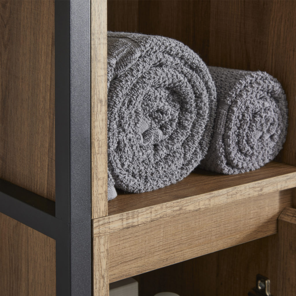 Close up of towels rolled up in open wooden cupboard with black frame