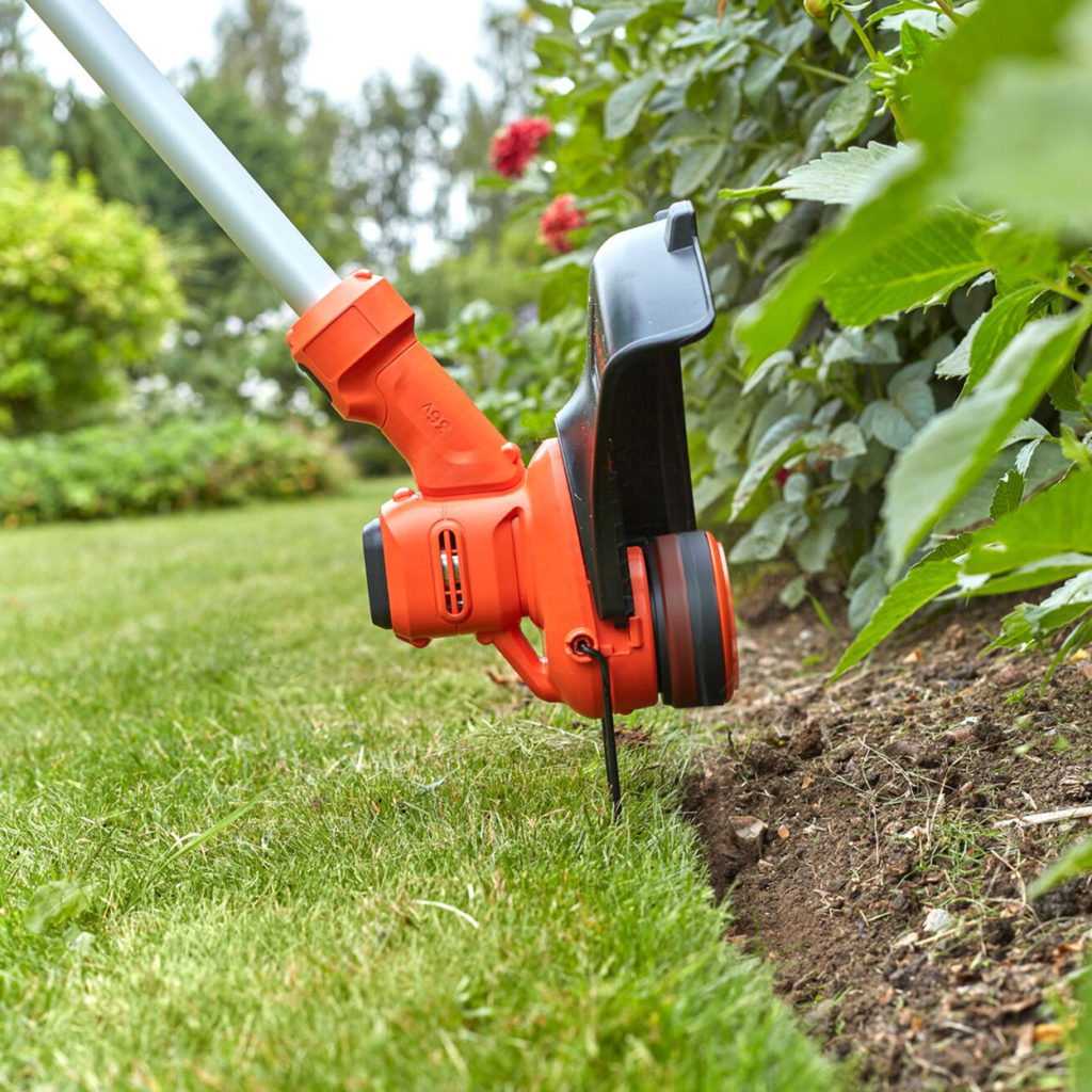 Close up of strimmer cutting garden edges 