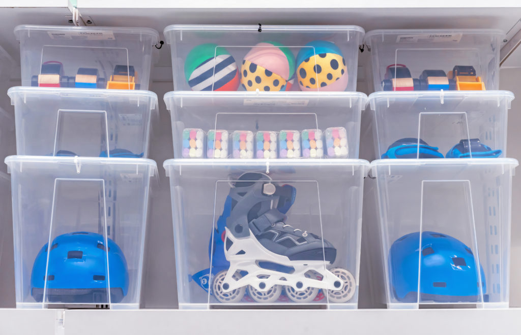 Multiple clear plastic storage bins placed on top of each other