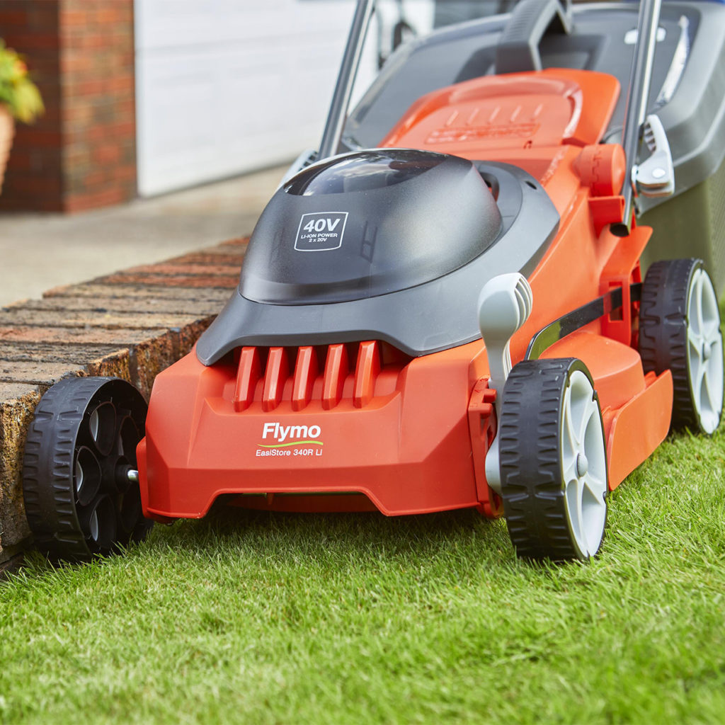 Close up of front of lawnmower cutting grass in a garden