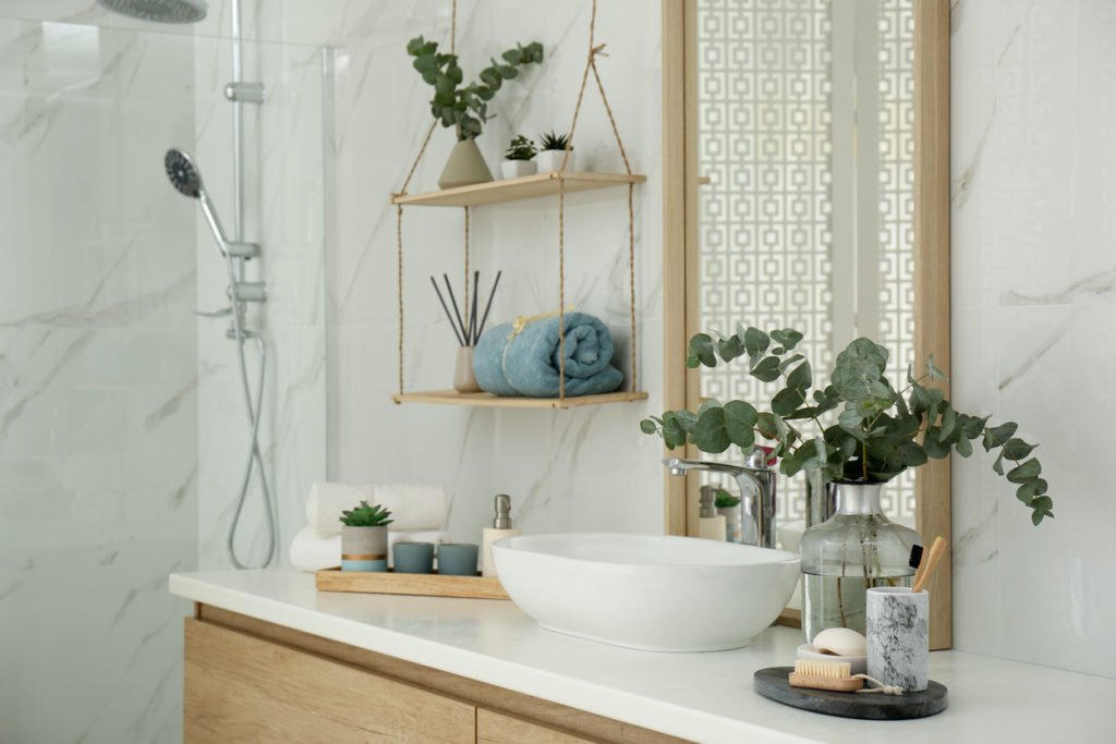 modern bathroom with fake plants scattered around as decor