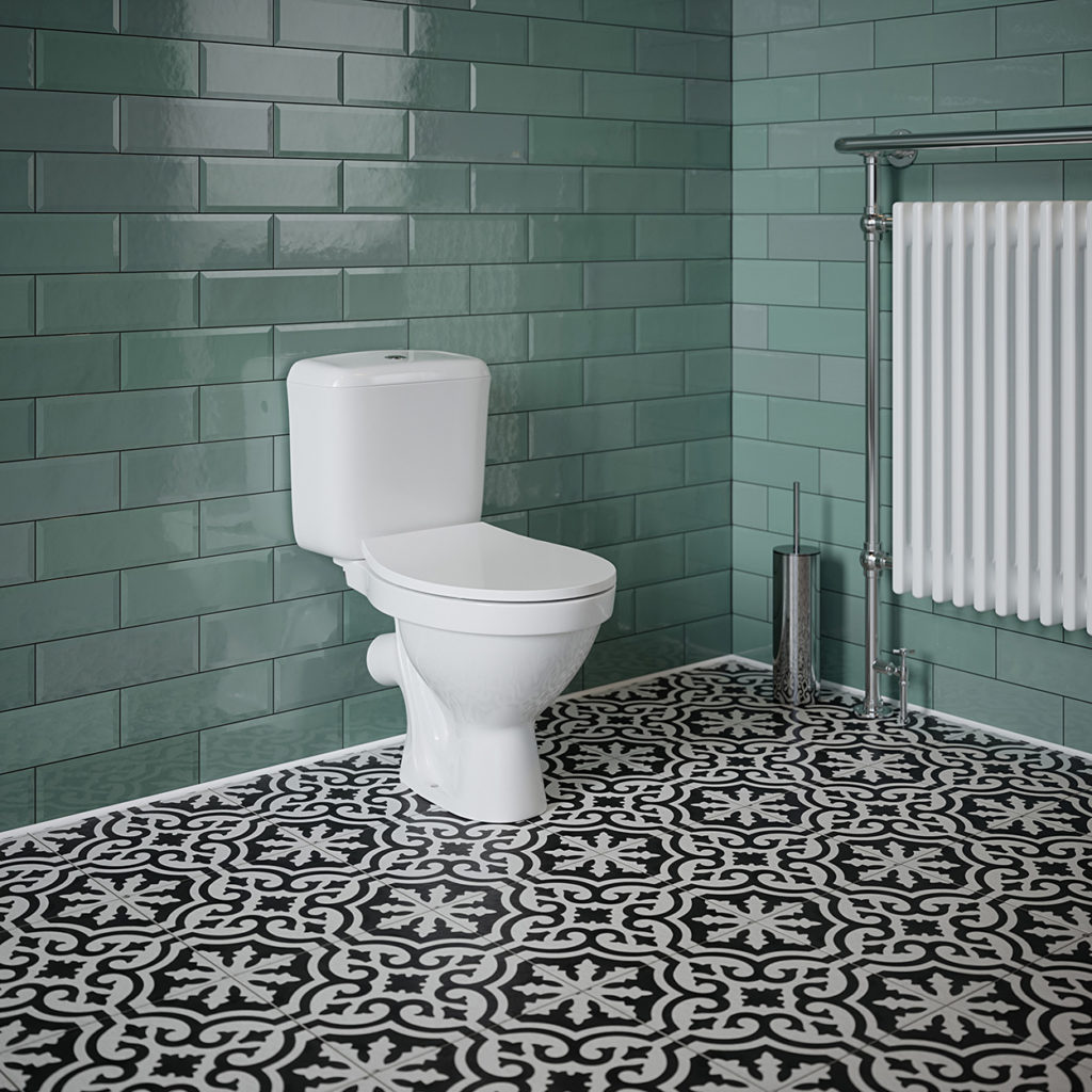 white toilet with white toilet seat in bathroom. turquoise tiled walls with black and white pattern floor tiles