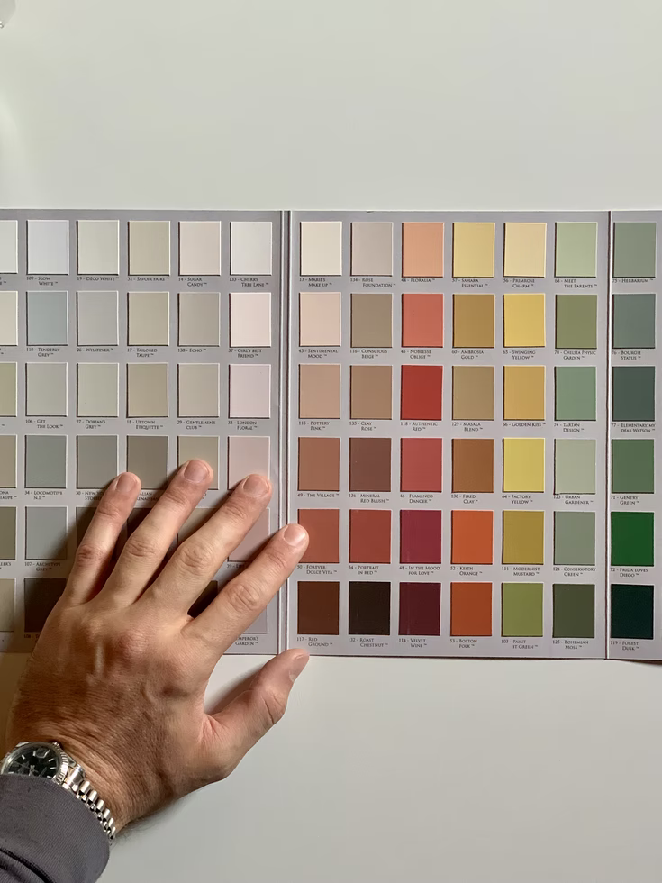 A man uses colour swatches so he can choose the best paint colours for his home.