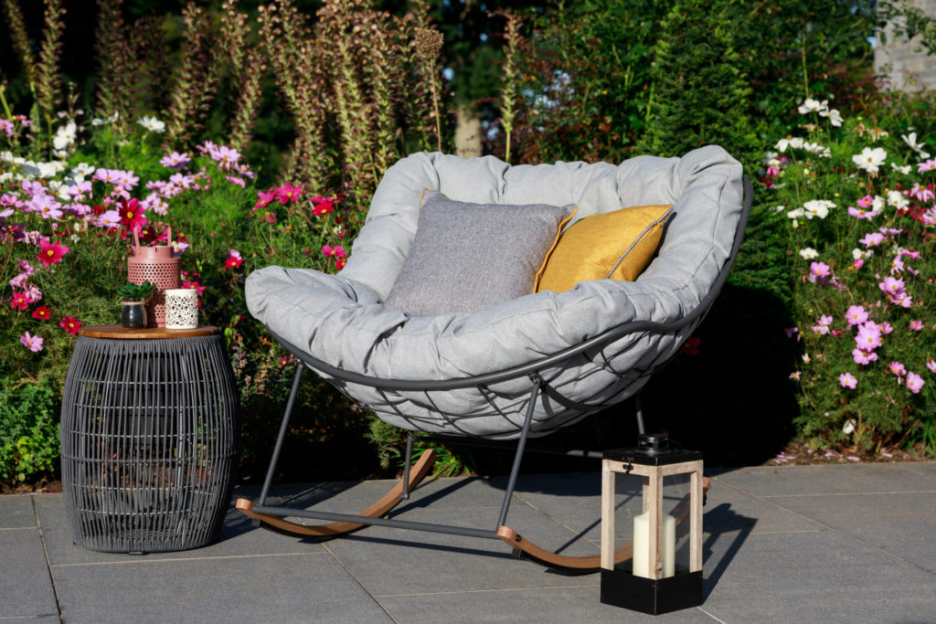 grey rocking chair set in sunny garden 