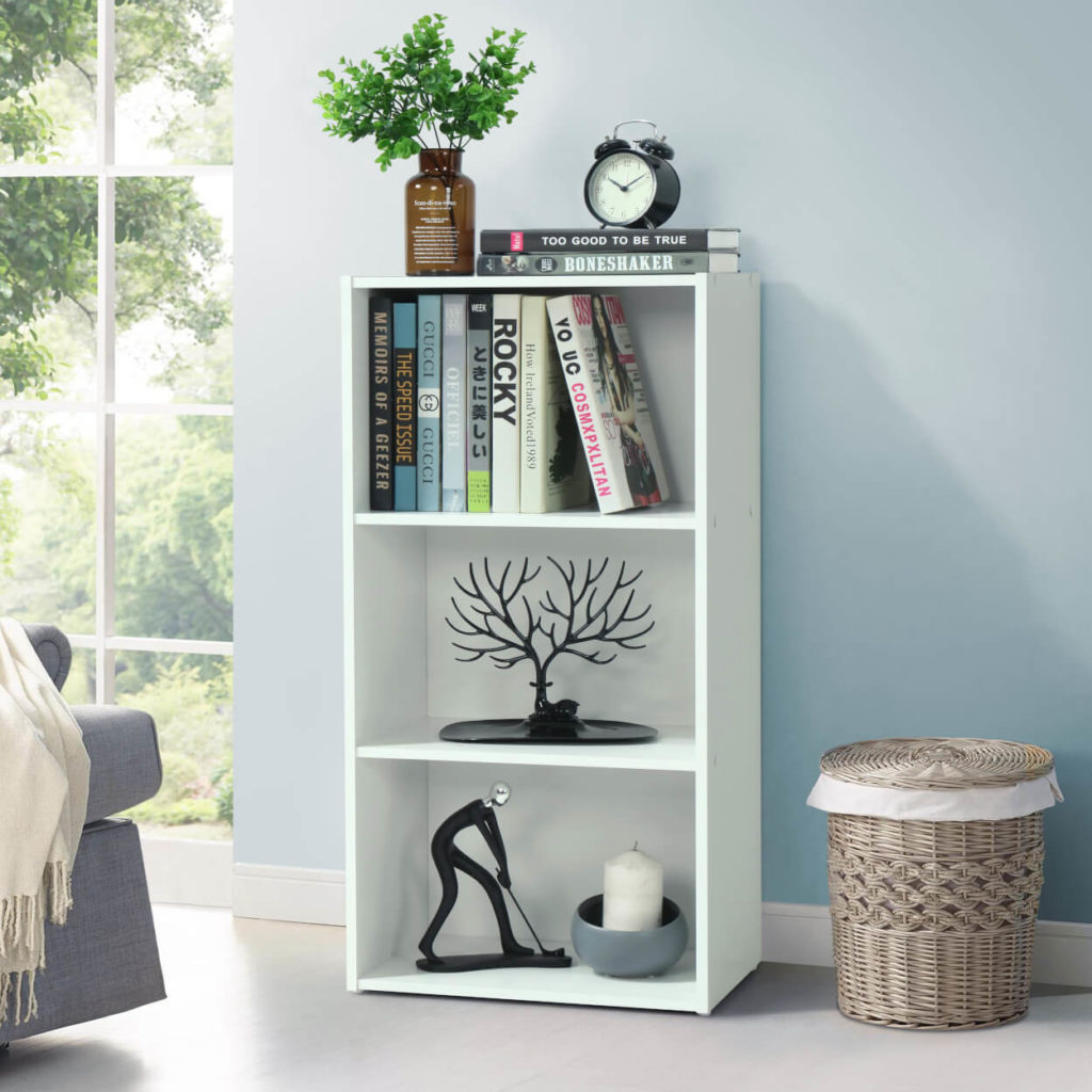 White shelving unit in a room decorated with books and candles 