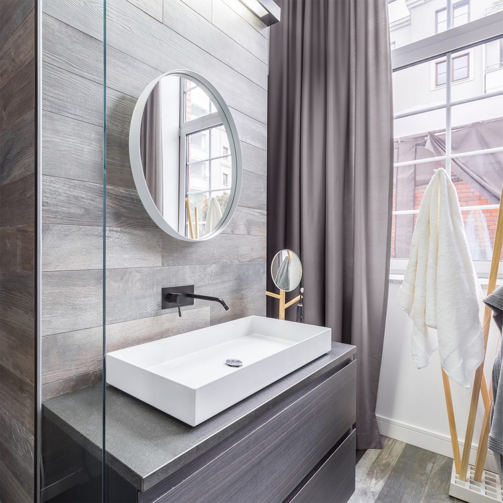 light bathroom with white mirror and white sink