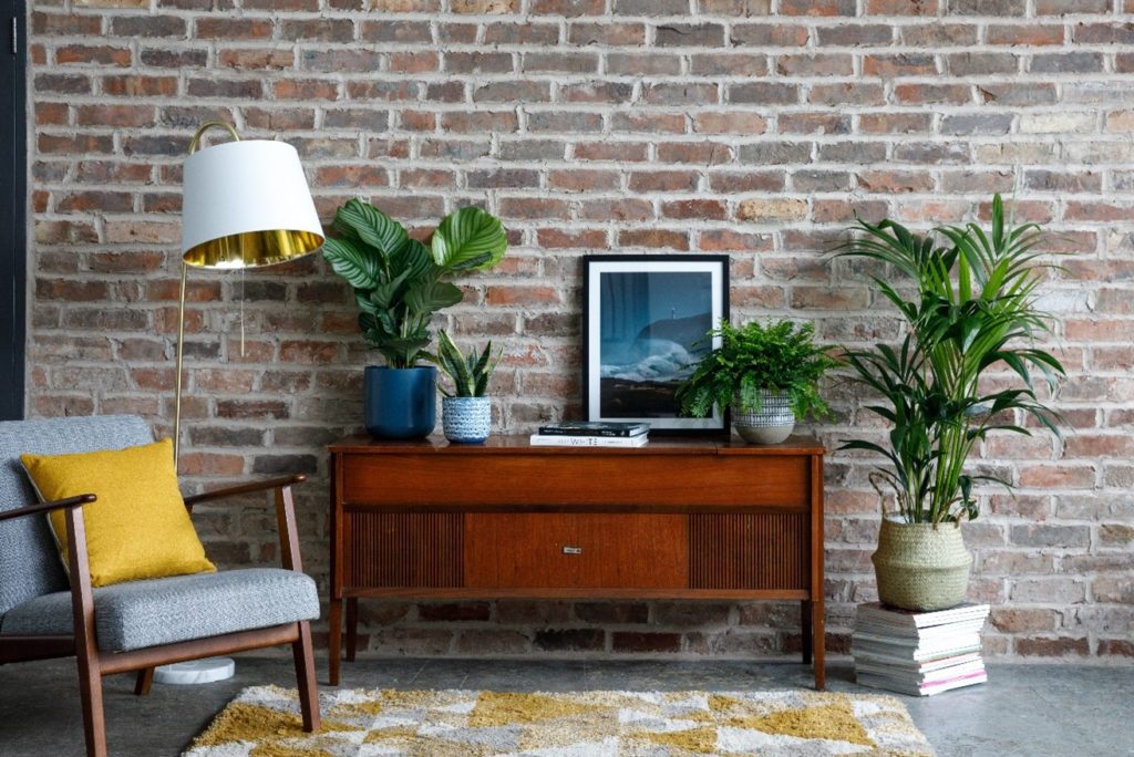 70s vintage side table with plants, brick wall and accessories.