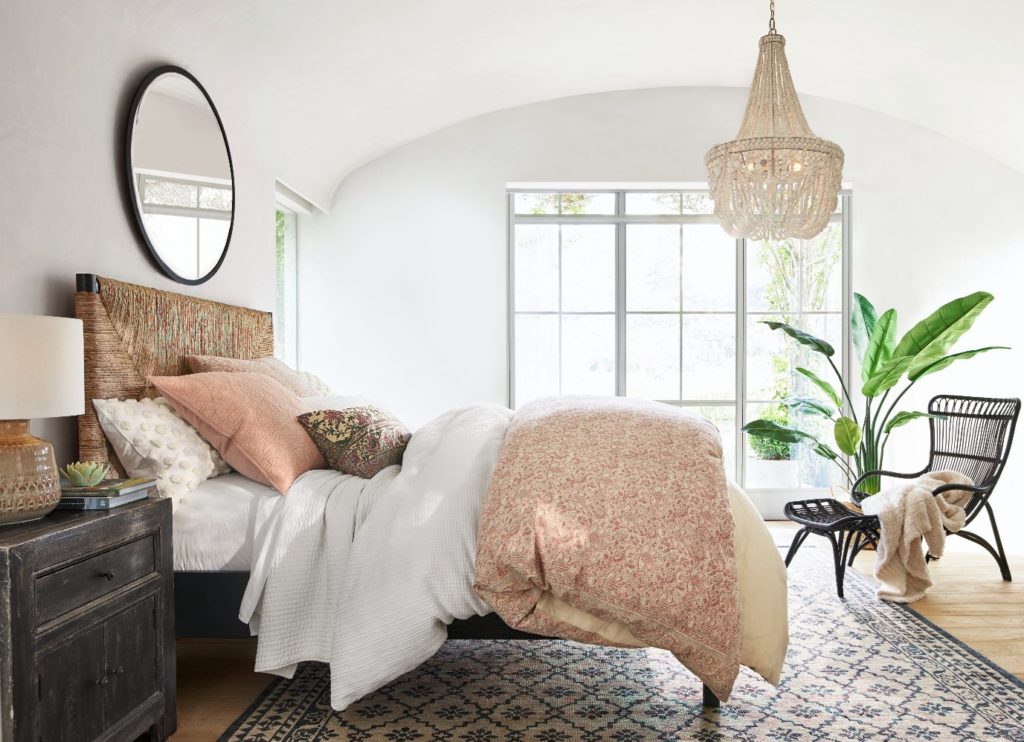 Neutral coloured bedroom with glamourous mirror.