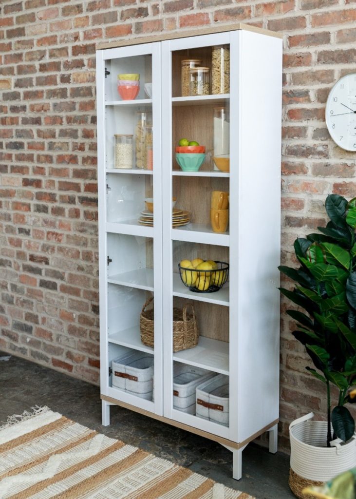 Kitchen storage unit against a brick wall.