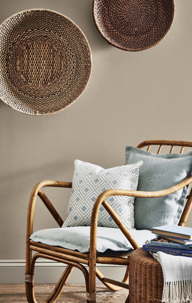 Wooden chair against a brown painted wall.