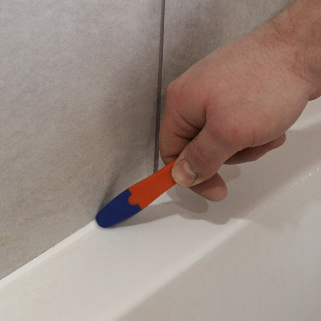 A man using a sealant smoother to achieve a watertight seal