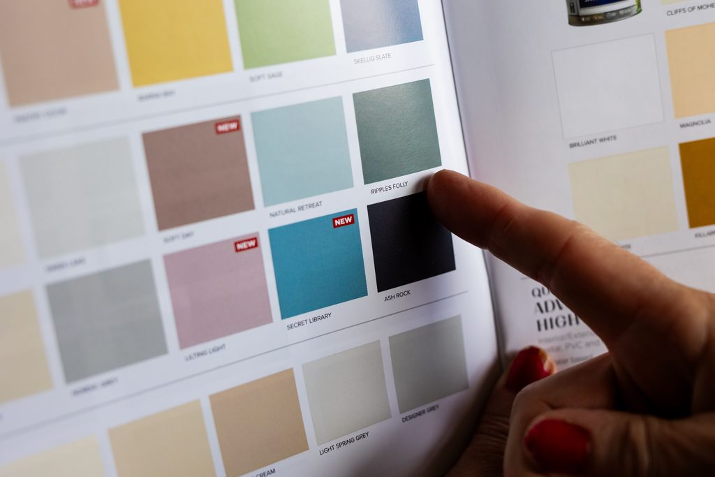 Image of a paint colour chart, with a finger pointing to ripples folly colour