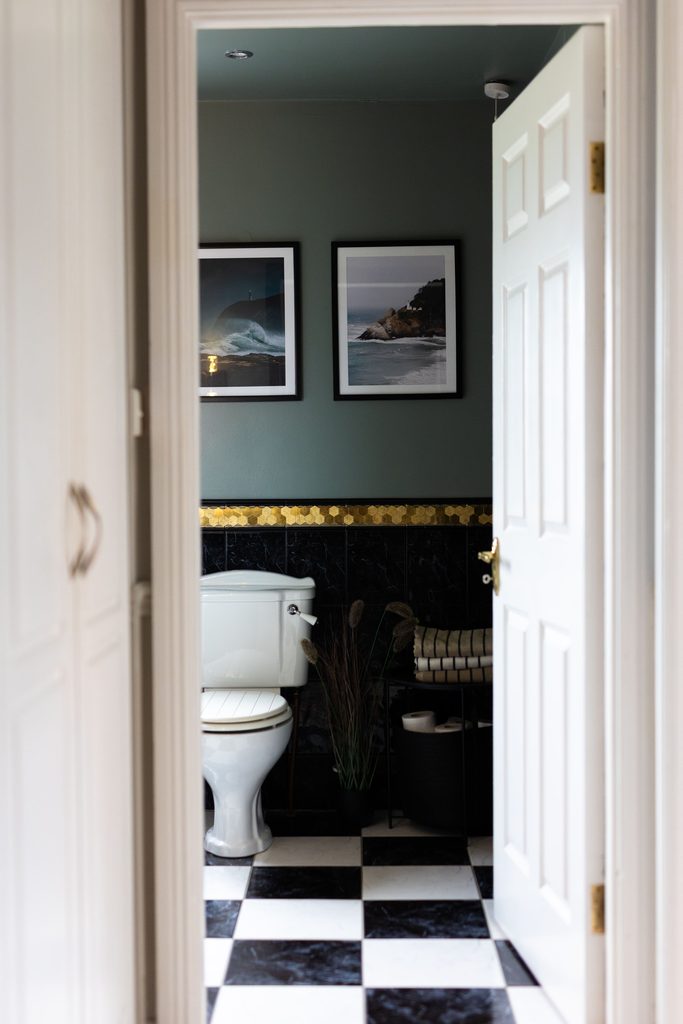 image of a bathroom with white and black tiling with ripples folly coloured walls